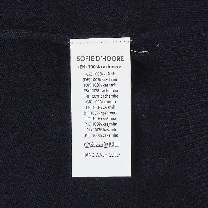 Sofie D'Hoore sleeveless turtleneck knit top in deep navy, featuring a ribbed roll neck, extended cap shoulders, and a relaxed boxy silhouette