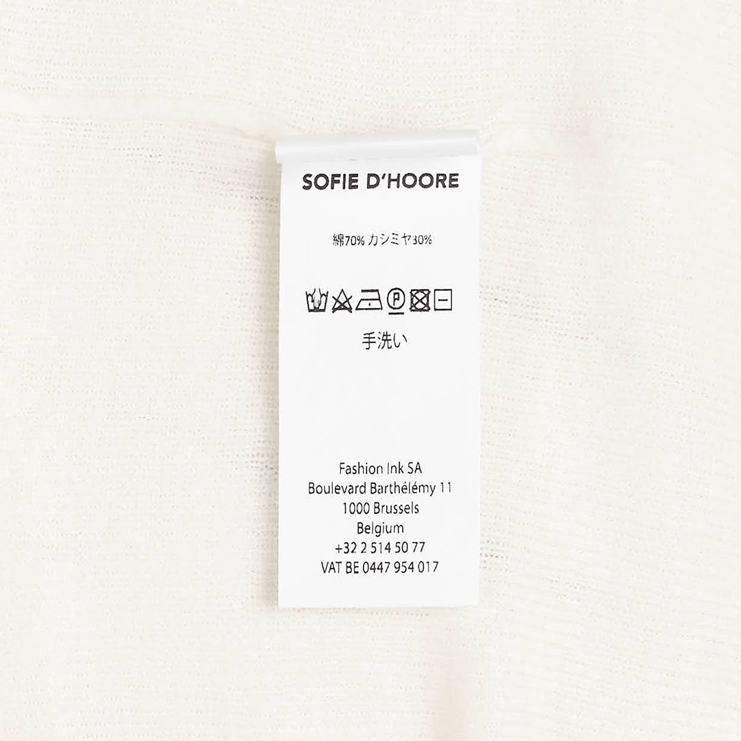 Sofie D'Hoore long sleeve turtleneck sweater in ivory fine-gauge knit with wide ribbed cuffs and foldover collar, displayed flat on a white background