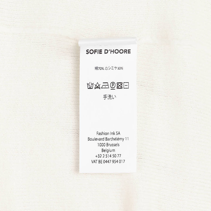 Sofie D'Hoore long sleeve turtleneck sweater in ivory fine-gauge knit with wide ribbed cuffs and foldover collar, displayed flat on a white background