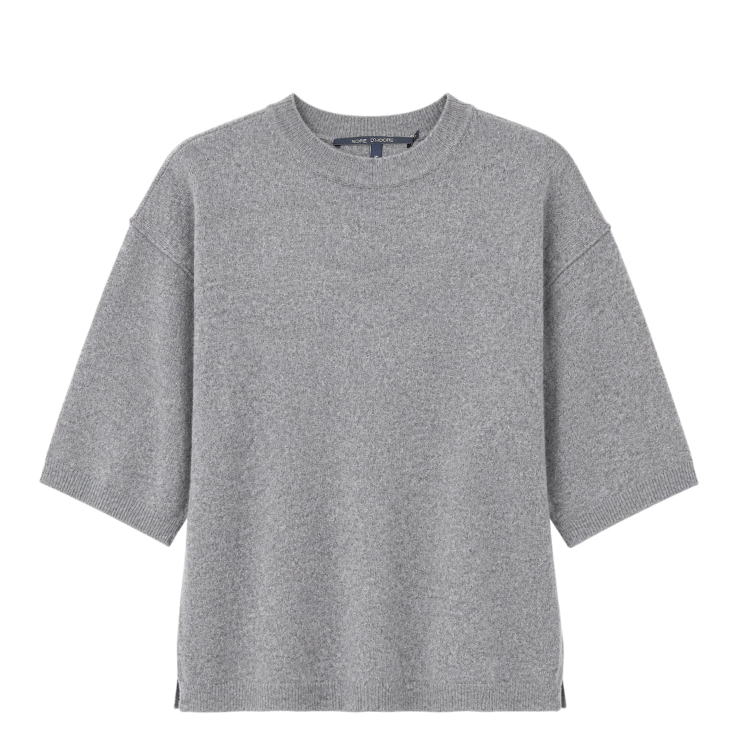 Sofie D'Hoore short sleeve knit top in heather grey with a relaxed boxy silhouette, dropped shoulders, ribbed crewneck, and ribbed cuffs, laid flat on a white background