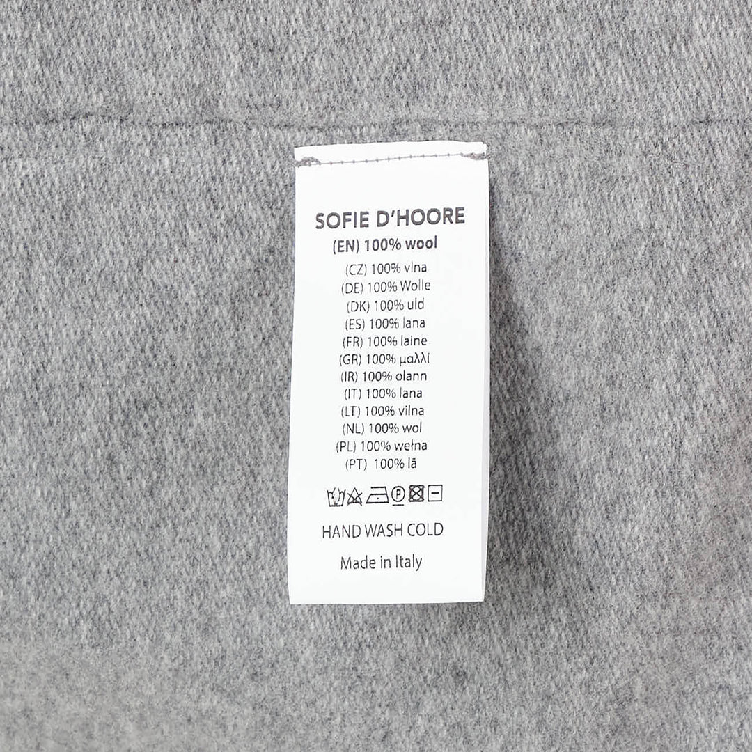 Sofie D'Hoore short sleeve knit top in heather grey with a relaxed boxy silhouette, dropped shoulders, ribbed crewneck, and ribbed cuffs, laid flat on a white background