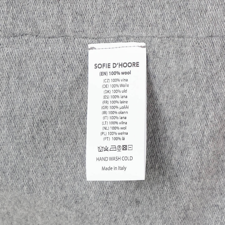 Sofie D'Hoore short sleeve knit top in heather grey with a relaxed boxy silhouette, dropped shoulders, ribbed crewneck, and ribbed cuffs, laid flat on a white background