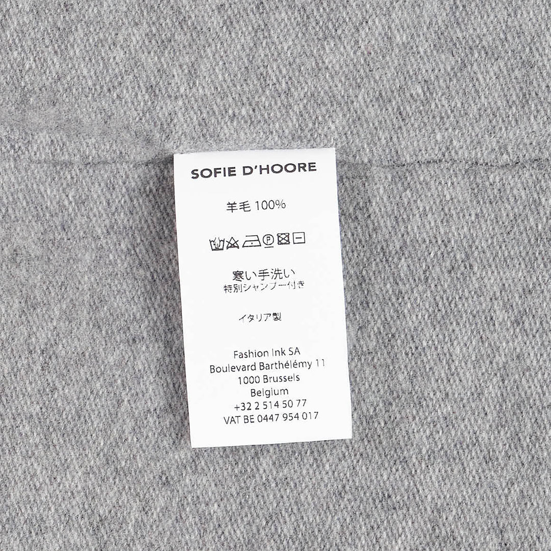 Sofie D'Hoore short sleeve knit top in heather grey with a relaxed boxy silhouette, dropped shoulders, ribbed crewneck, and ribbed cuffs, laid flat on a white background