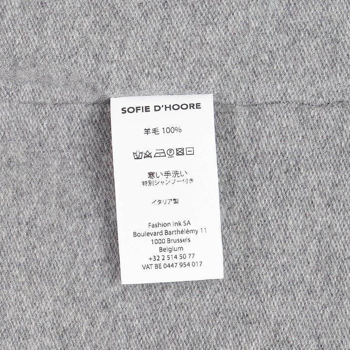 Sofie D'Hoore short sleeve knit top in heather grey with a relaxed boxy silhouette, dropped shoulders, ribbed crewneck, and ribbed cuffs, laid flat on a white background