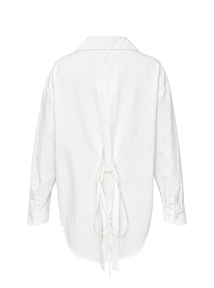 Musée RA white oversized shirt with pointed collar, button placket, chest pocket and open back tie detail, shown from the front - view 2