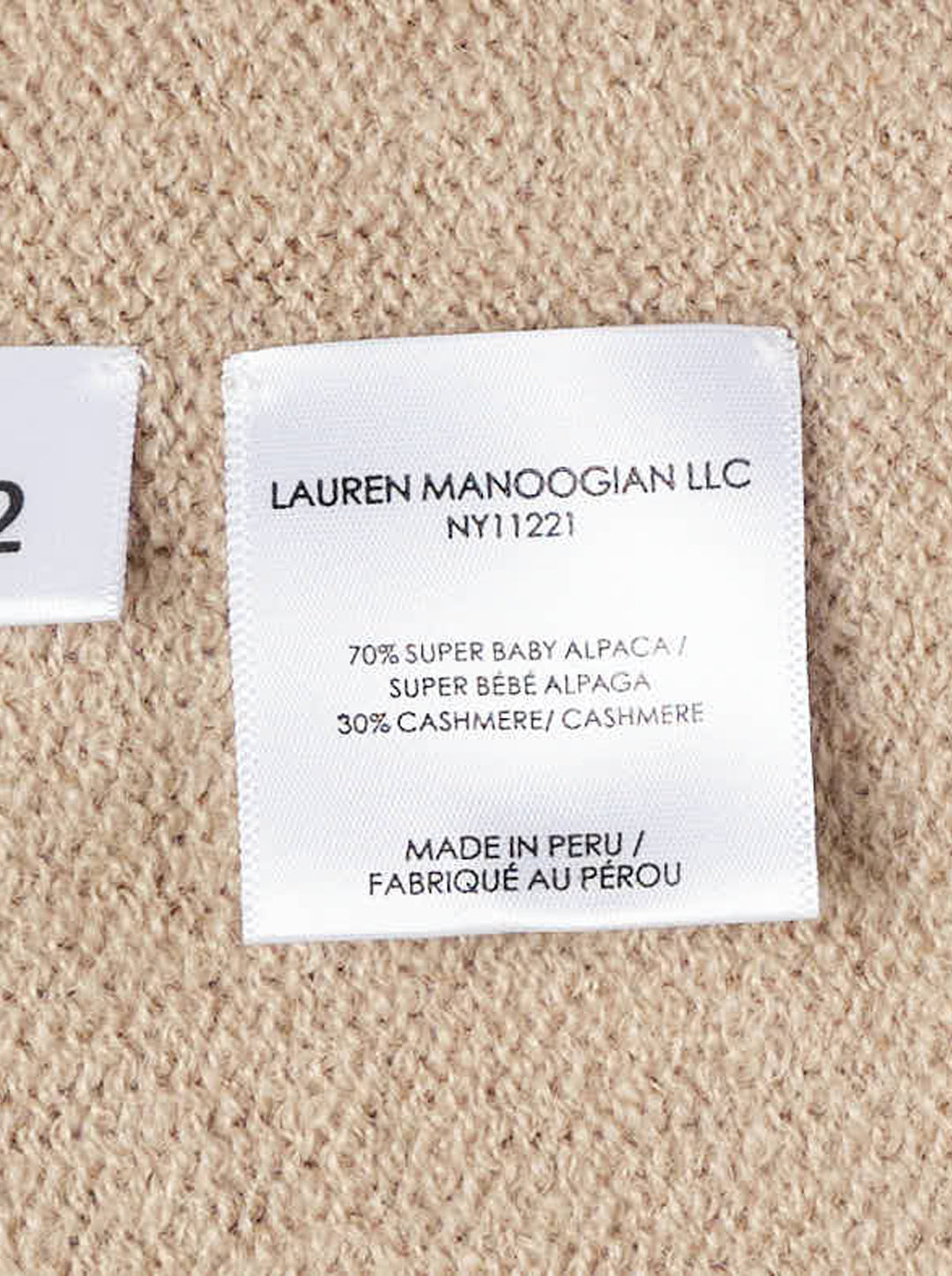 Lauren Manoogian Soft V Neck Sweater in camel, an oversized long-sleeve knit with a deep V neckline and rolled hem, shown flat from the front - view 3