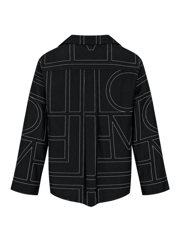 Totême Monogram Silk Pyjama Top in black, featuring all-over contrast-stitched monogram print, camp collar, partial button placket, and relaxed long-sleeve silhouette - view 2