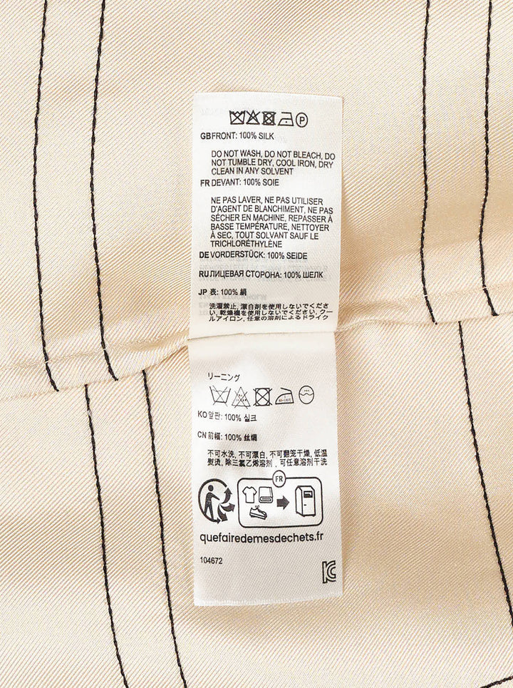 Totême Monogram Silk Pyjama Top in cream with dark outlined oversized logo lettering, notched lapel collar, button-through front, and long sleeves - view 3