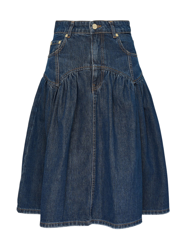 Ganni Slub Mix Denim Midi Skirt in washed indigo, featuring a high waistband, gathered tier seam, front patch pockets with gold rivets, and a full A-line silhouette with contrast orange topstitching