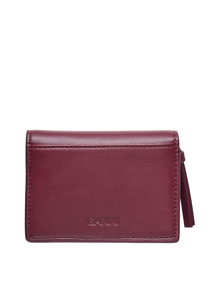 Ganni Bou Bear Print Card Holder in burgundy leather featuring an illustrated teddy bear and pine forest motif with a pink butterfly-knot clasp hardware detail - view 2