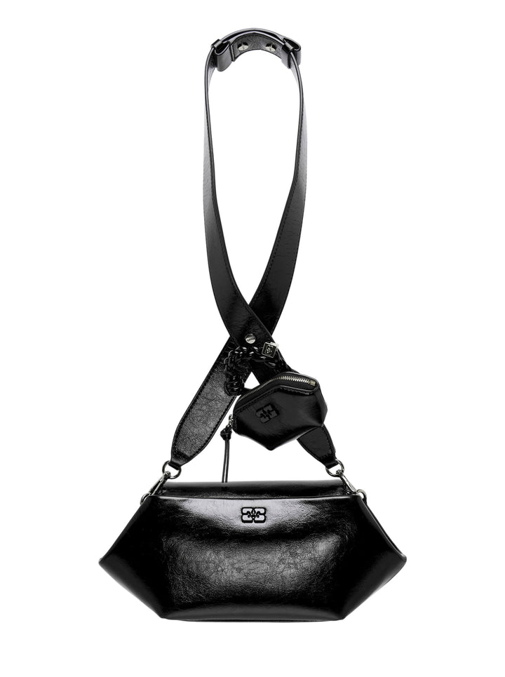 Ganni Bou East/West Box crossbody bag in glossy black with wide crossed strap, braided charm and detachable mini zip pouch