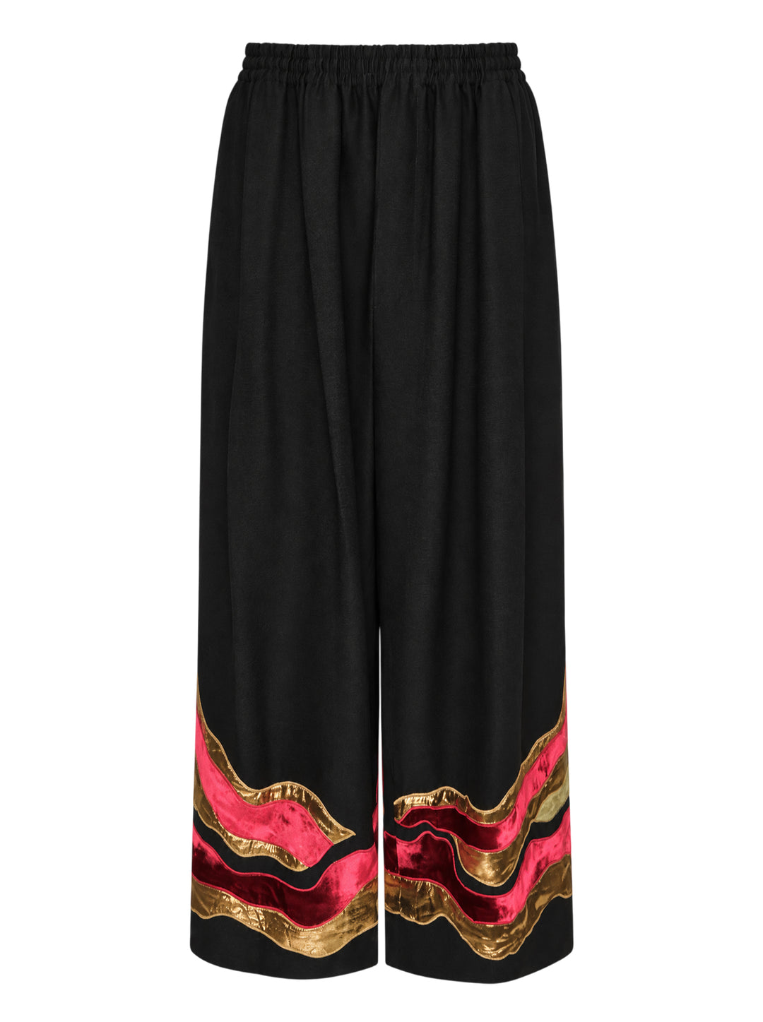 Biyan black gabardine wide leg pants with layered wavy velvet and gold metallic appliqué trim at the hem, elastic waistband, front view on white background
