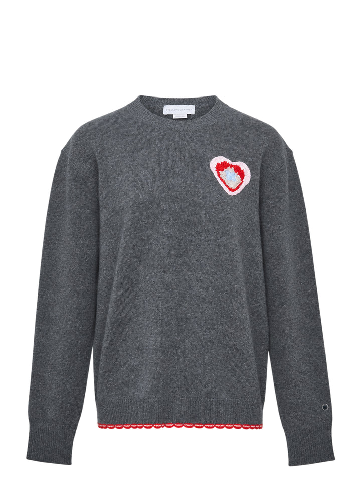 Stella McCartney heather grey wool jumper with multicolour crochet heart appliqué at the chest and red scalloped logo hem trim, front view