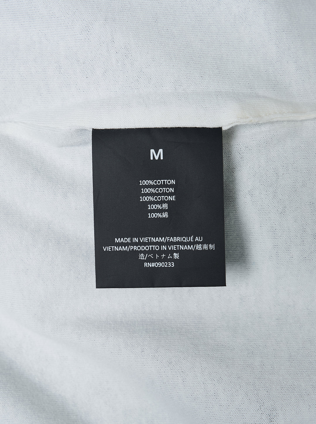 Fear of God ESSENTIALS Classic Double Layer Tee in black with white undertee at the neckline and hem and tonal embroidered logo at the chest - view 3