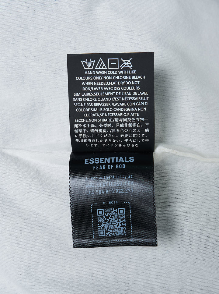Fear of God ESSENTIALS Classic Double Layer Tee in black with white undertee at the neckline and hem and tonal embroidered logo at the chest - view 4