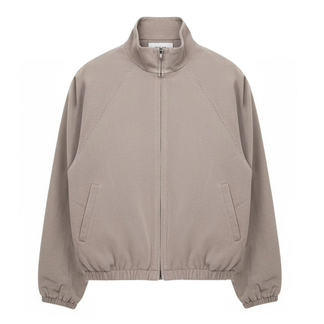 Fear of God Essentials Modern Filled Blouson Jacket in taupe, featuring a full-length zip, stand collar, raglan sleeves, and elasticated hem and cuffs, shown flat on a white background