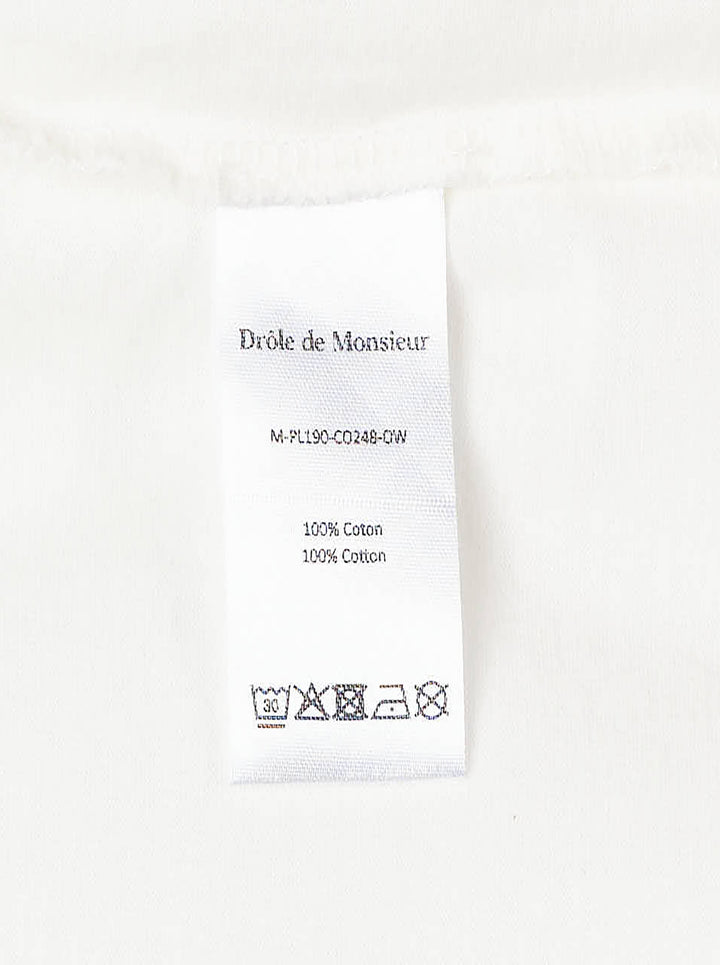 Drôle de Monsieur Slogan Long Sleeve Polo in cream with forest-green contrast collar, striped ribbed cuffs, and 'Not From Paris Madame' chest embroidery - view 4