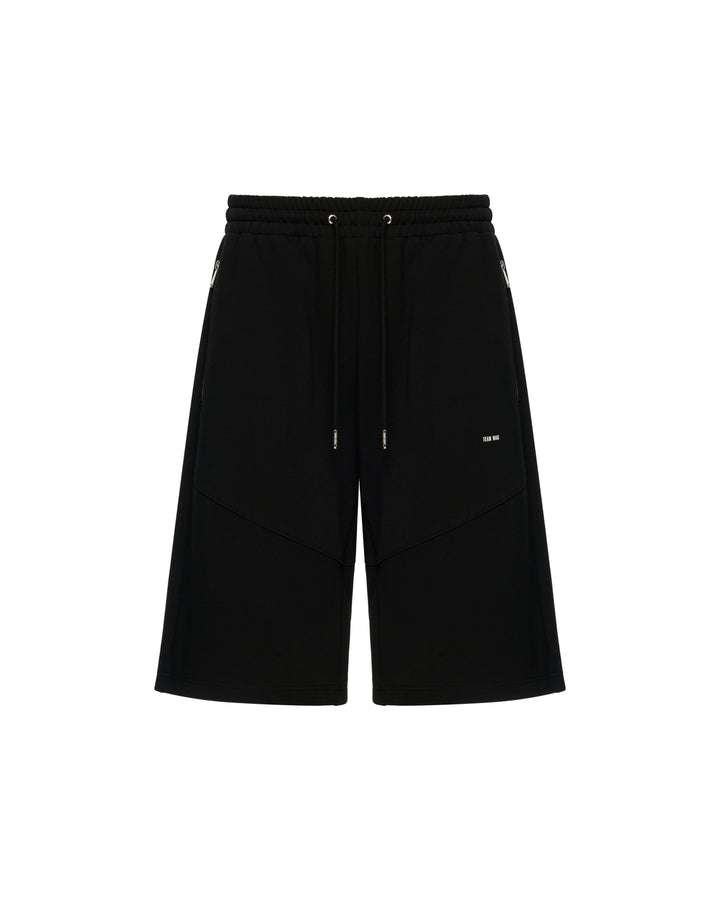 TEAM WANG design Original 1 Casual Shorts in black, featuring an elasticated drawstring waistband, zip side pockets, chevron panel seaming on the lower leg, and an embroidered logo at the hip