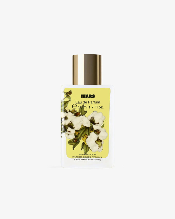 Tears Eau de Parfum 50ml by Comme des Garçons Parfums in a white glass bottle with a gold cap and yellow cotton blossom label