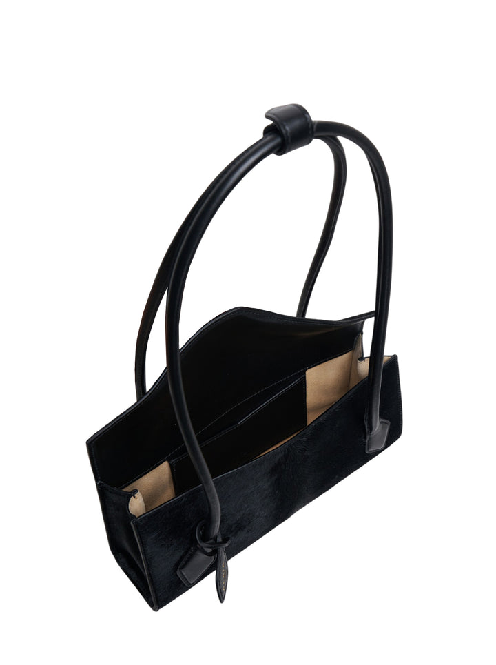 Alaïa Teckel Flap Small bag in black haircalf with sculptural double-looped handle and envelope flap closure, front view - view 3