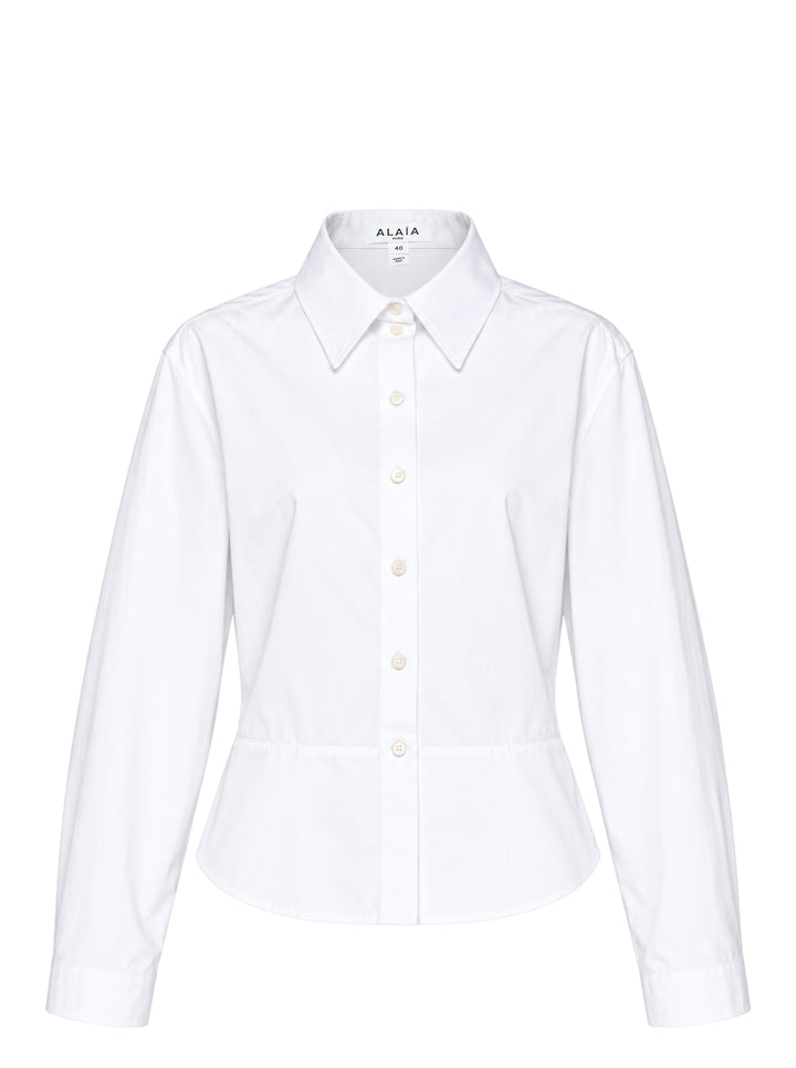 Alaïa Basque Cotton Poplin Shirt in white, featuring a sculpted waist seam, peplum hem, point collar, and mother-of-pearl button front fastening