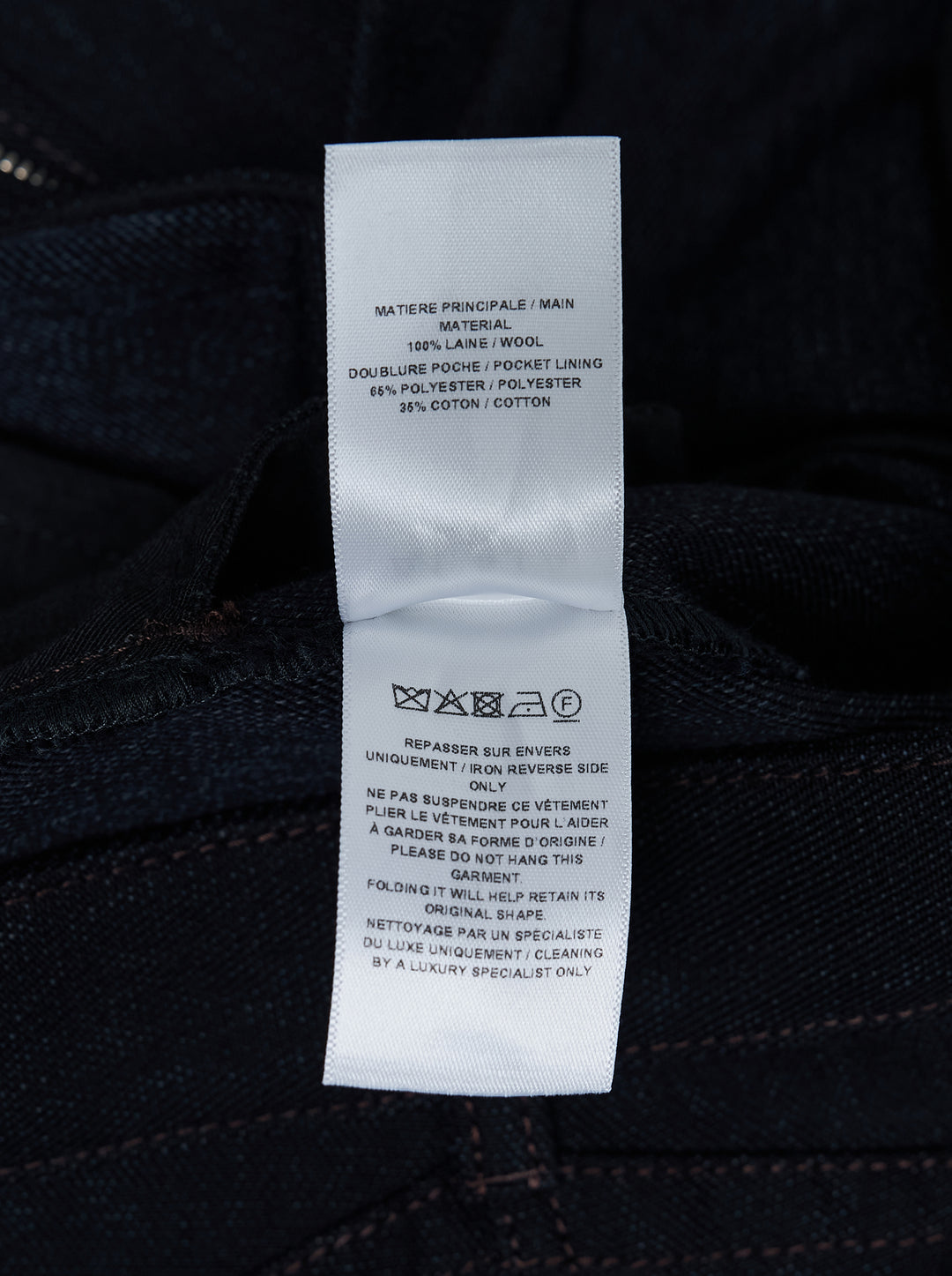 Alaïa round pants in dark navy wool denim with a high waist, curved barrel leg and contrast topstitching, shown from the front - view 3