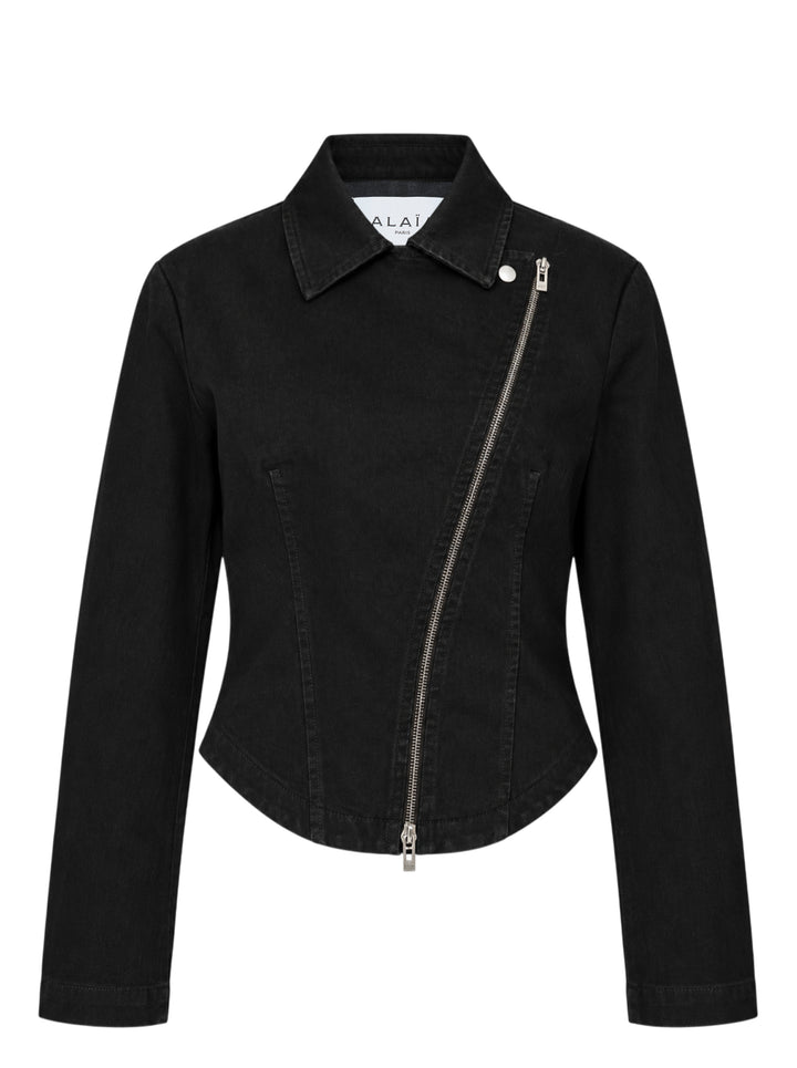 Alaïa Black Denim Biker Jacket with asymmetric silver-tone zip, corset seaming, and cropped curved hem, shown flat on white background