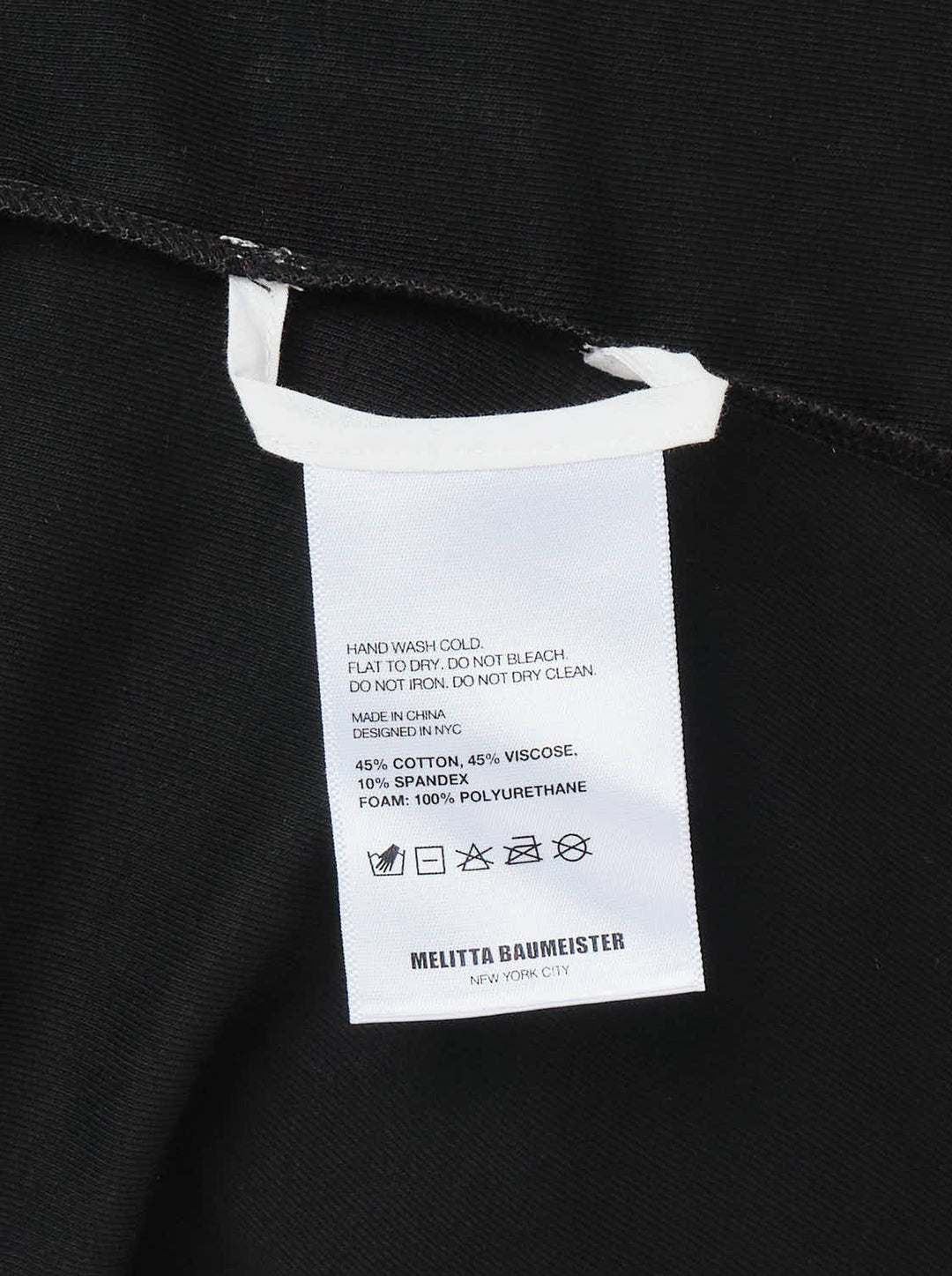 Melitta Baumeister Foamy Shoulder Tee in black, featuring exaggerated sculptural puff shoulders, ribbed crew neckline, and a fitted short-sleeve silhouette, shown on a flat lay against a white background - view 3