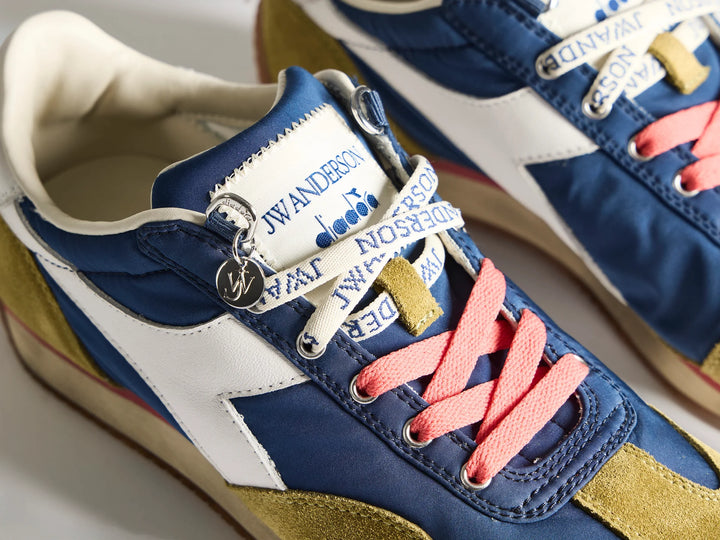 Diadora x JW Anderson retro nylon sneaker in blue with khaki suede overlays, coral laces, and a white Diadora logo stripe, set against a white background - view 5