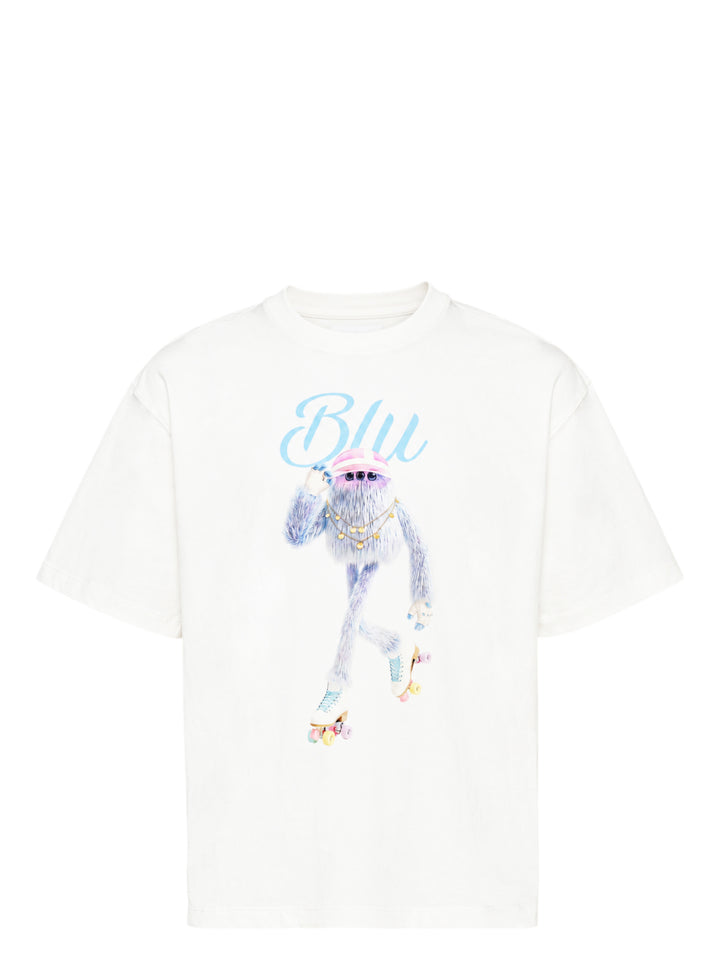 The Fluffadoos Blu Name Story Tee in white, featuring a printed illustration of a fuzzy blue creature wearing roller skates, a gold chain, and a pink visor, with 'Blu' in sky blue script above