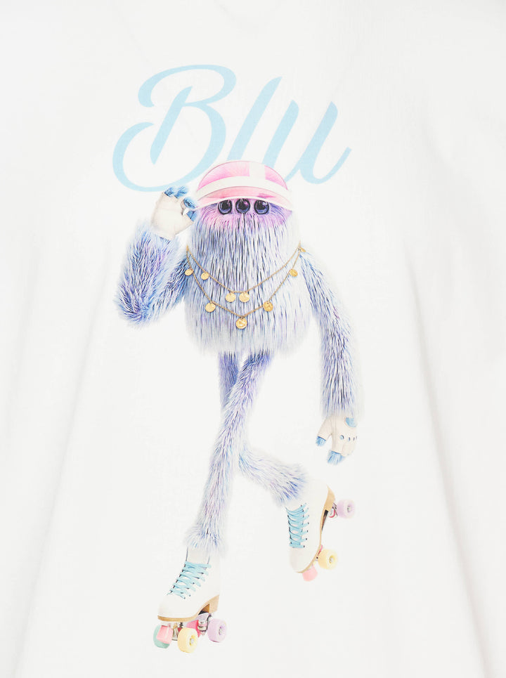 The Fluffadoos Blu Name Story Tee in white, featuring a printed illustration of a fuzzy blue creature wearing roller skates, a gold chain, and a pink visor, with 'Blu' in sky blue script above - view 3