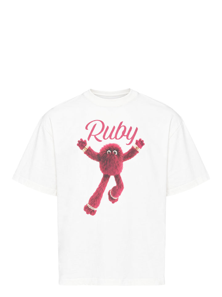 The Fluffadoos Ruby Name Story Tee in white, featuring a large graphic of the ruby-red furry Ruby character with pearl accessories and cursive 'Ruby' script lettering on the front