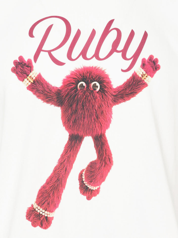 The Fluffadoos Ruby Name Story Tee in white, featuring a large graphic of the ruby-red furry Ruby character with pearl accessories and cursive 'Ruby' script lettering on the front - view 3