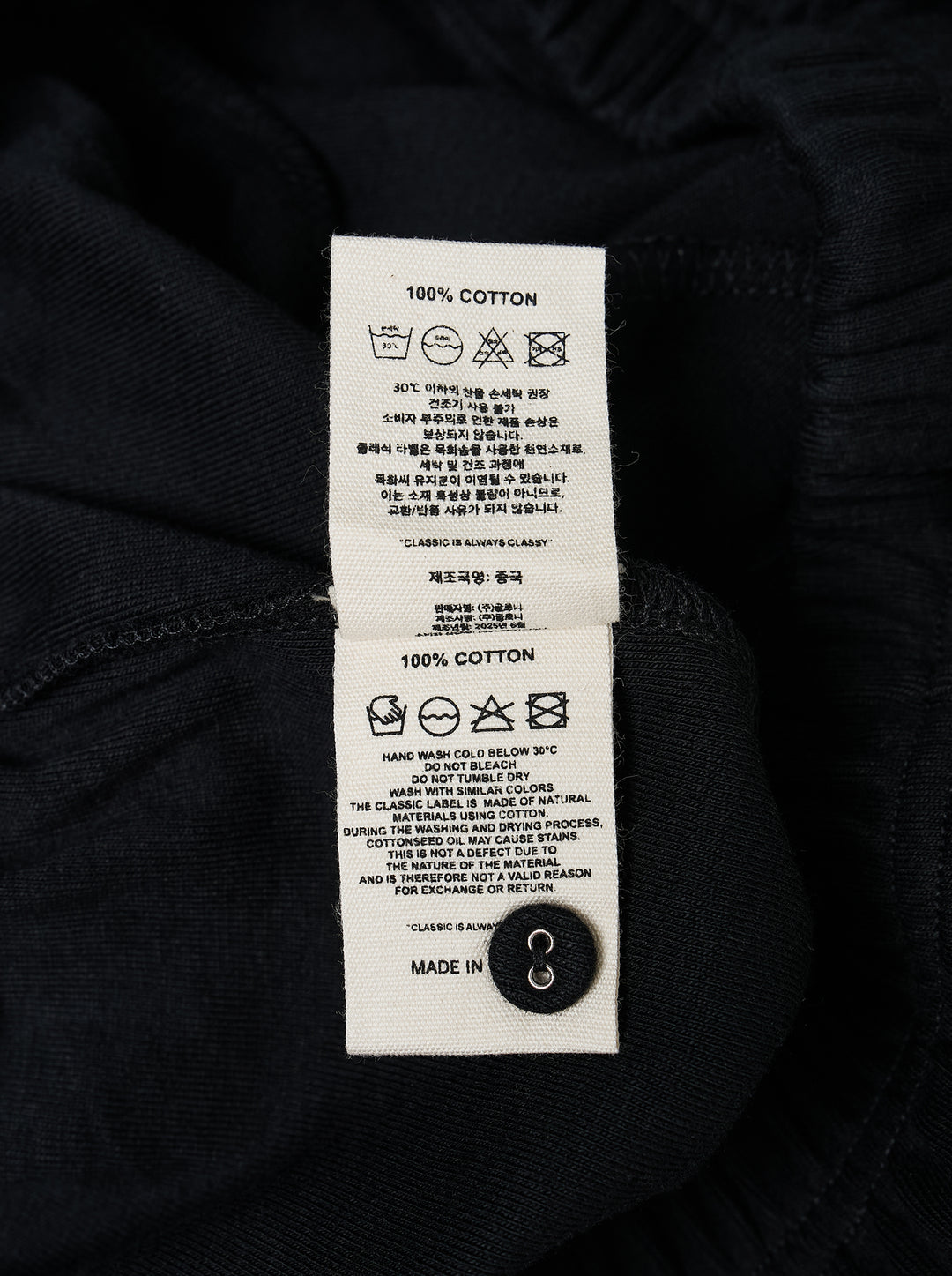 Glowny Button Fly Wide Leg Pants in black, featuring an elasticated waistband, three-button fly placket, wide-leg silhouette, and woven brand label tab at the hip - view 3