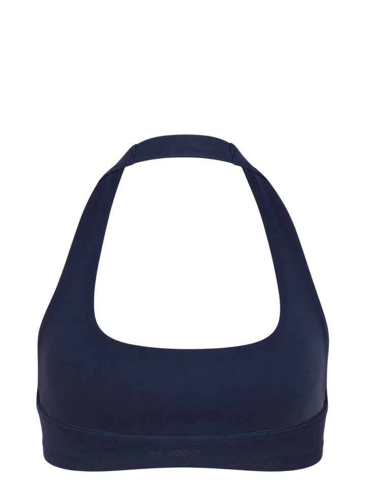 Navy halter-neck bralette from Nike X Jacquemus with a scoop front neckline and open back, shown flat against a white background - view 2