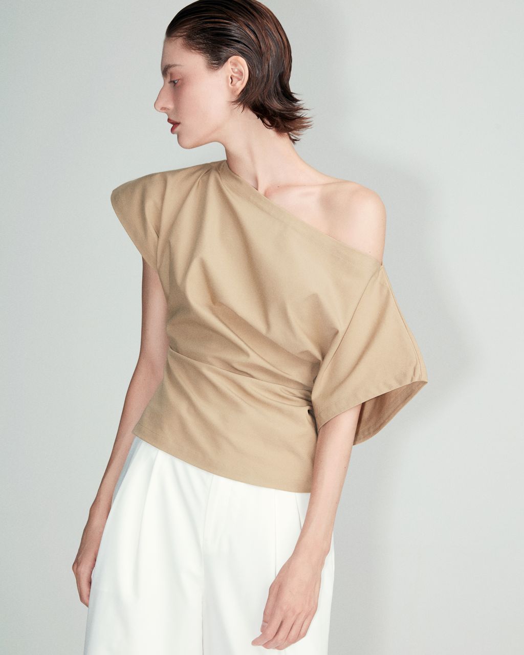 Club21 Collection Tate light stretch rayon linen top in beige, featuring a wide boatneck, batwing short sleeves, and a ruched gathered waistband