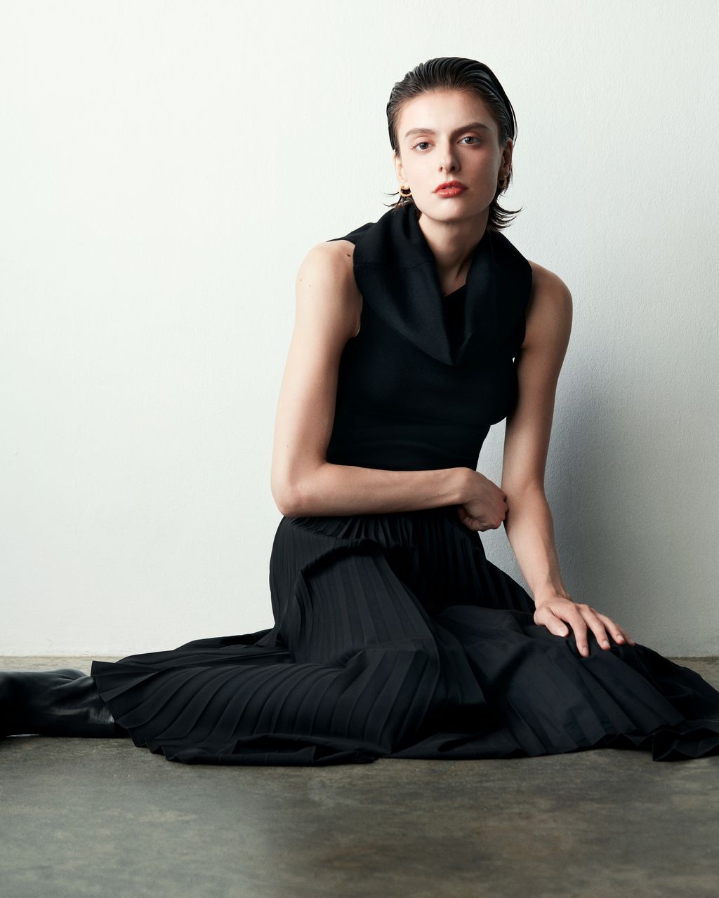 Club21 Collection Isla black pleated asymmetric midi skirt with handkerchief hem and elasticated waistband, displayed flat on white background