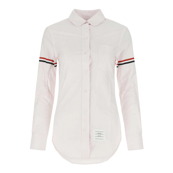 Thom Browne classic long sleeve light blue pinstripe shirt with tricolor grosgrain ribbon armbands, front view on white background