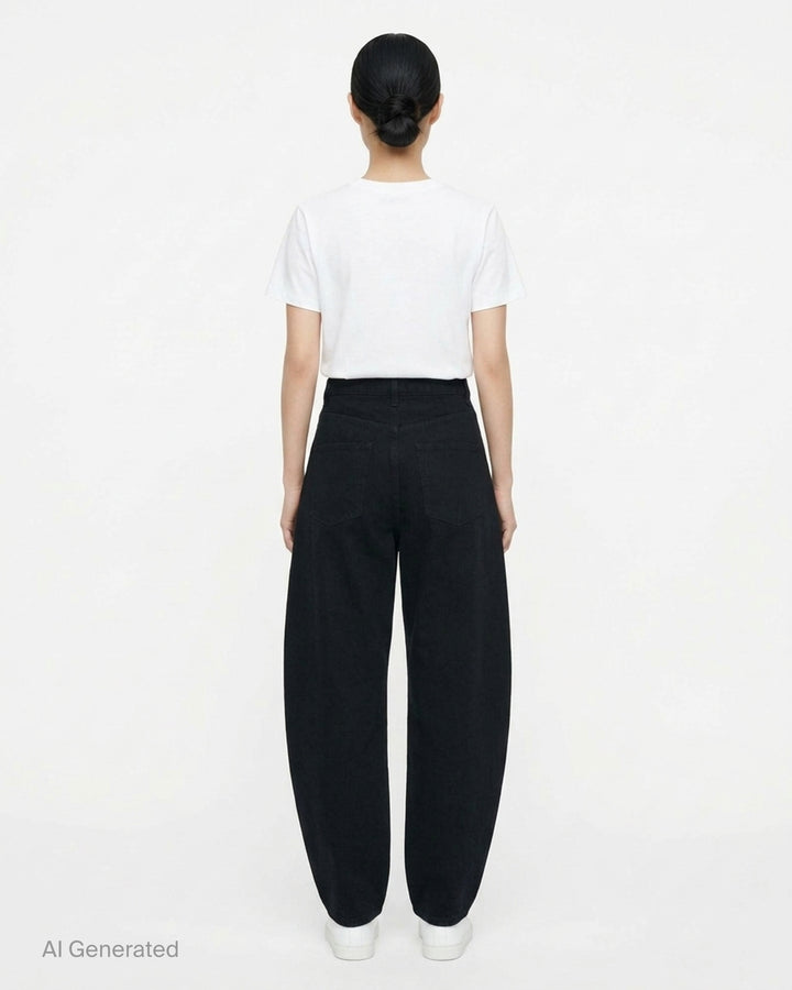 Alaïa black denim round pants with a high waist, five-pocket design and sculpted curved leg, shown from the front - back