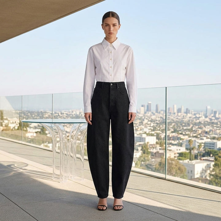 Alaïa black denim round pants with a high waist, five-pocket design and sculpted curved leg, shown from the front - lifestyle