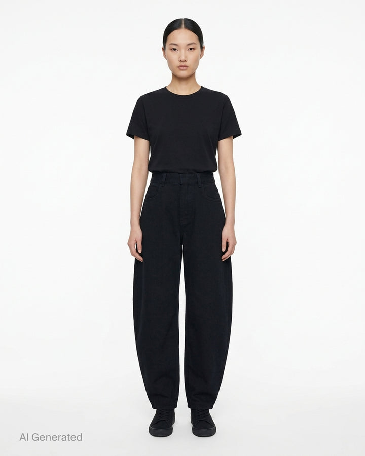 Alaïa round black denim jeans with a high waist and sculpted curved leg, shown front view - front