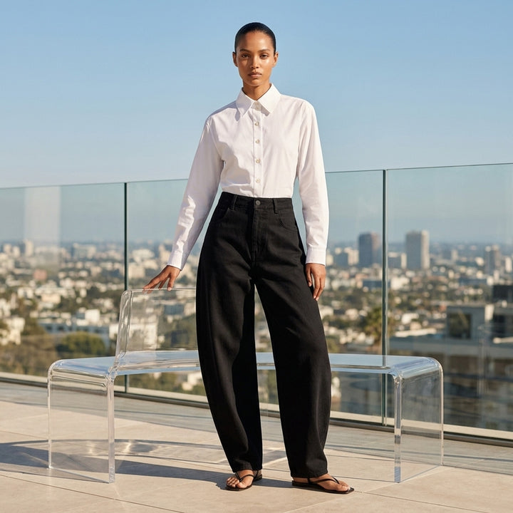 Alaïa round black denim jeans with a high waist and sculpted curved leg, shown front view - lifestyle