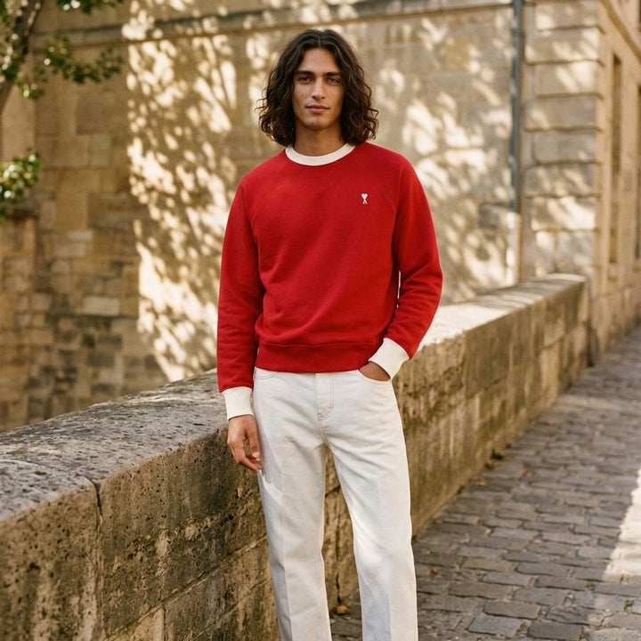 AMI Paris Bicolor Crewneck Sweatshirt in red with cream contrast ribbed collar and cuffs, featuring an embroidered Ami de Cœur logo on the chest - lifestyle