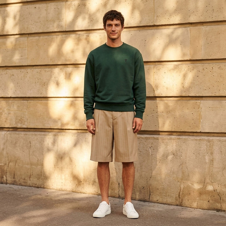 AMI forest green crewneck sweatshirt with ribbed trim and a small embroidered Ami de Coeur logo at the chest - lifestyle