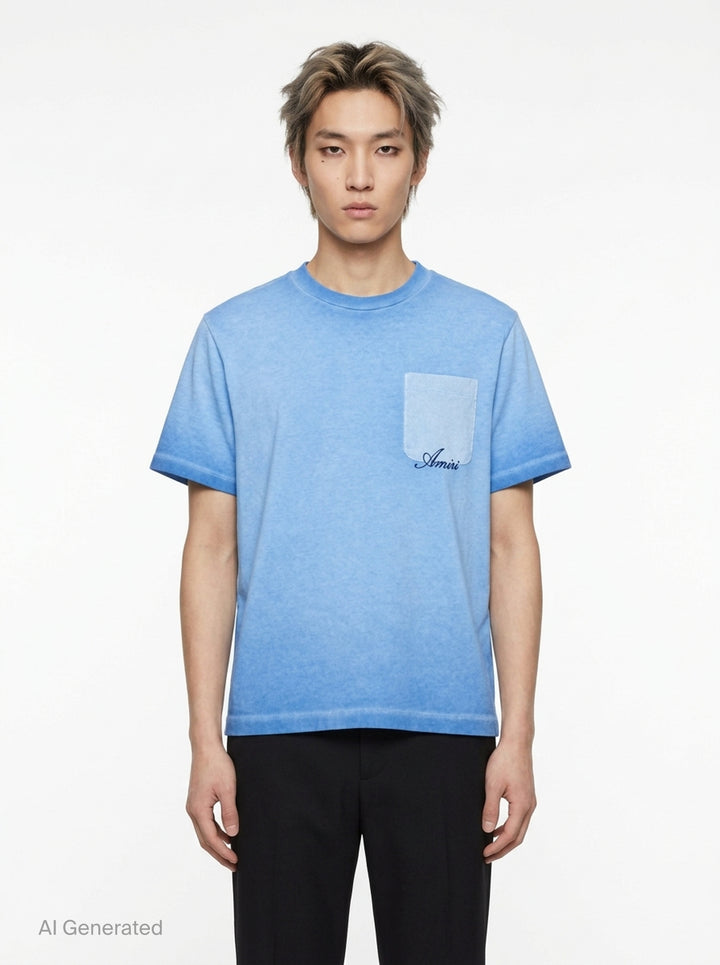 Amiri Faded Pocket Box Tee in stonewashed grey with a contrast suede chest pocket and cursive Amiri script embroidery - front
