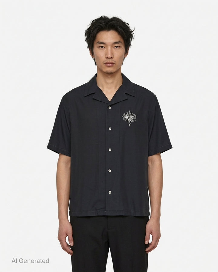Amiri Lasso oversized camp shirt in black with an ornate embroidered logo on the chest, camp collar and mother-of-pearl buttons - front