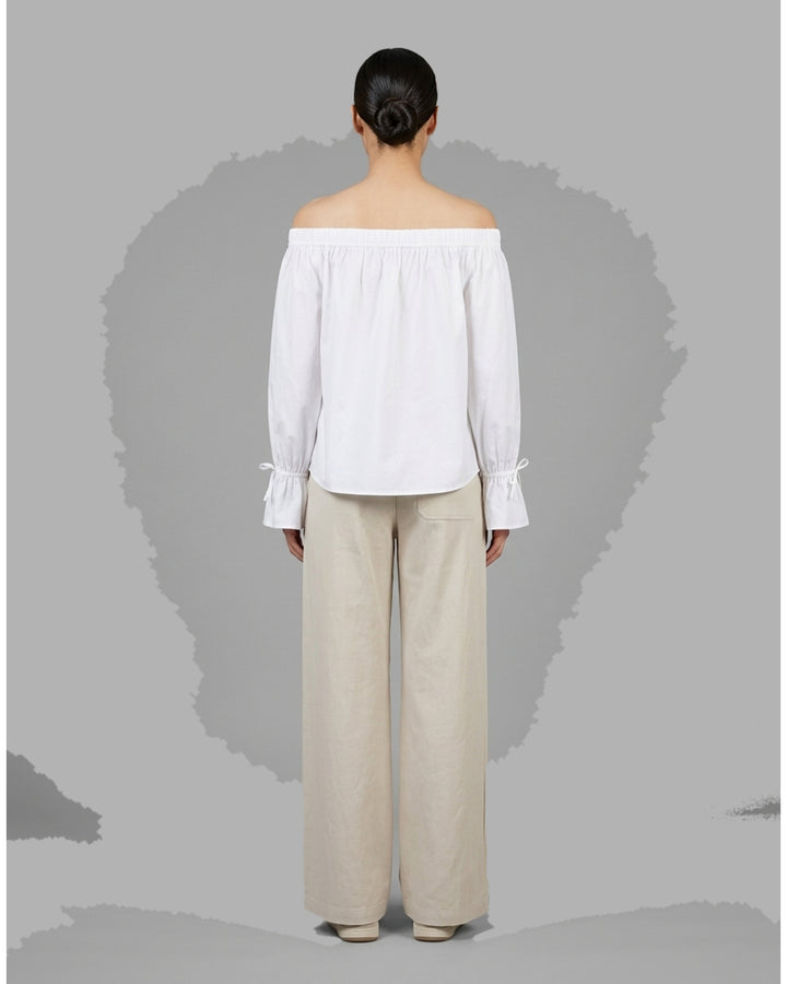 Club21 Collection Adele wide-leg pants in light neutral nylon cotton twill with patch pockets and double button waistband, front view - back