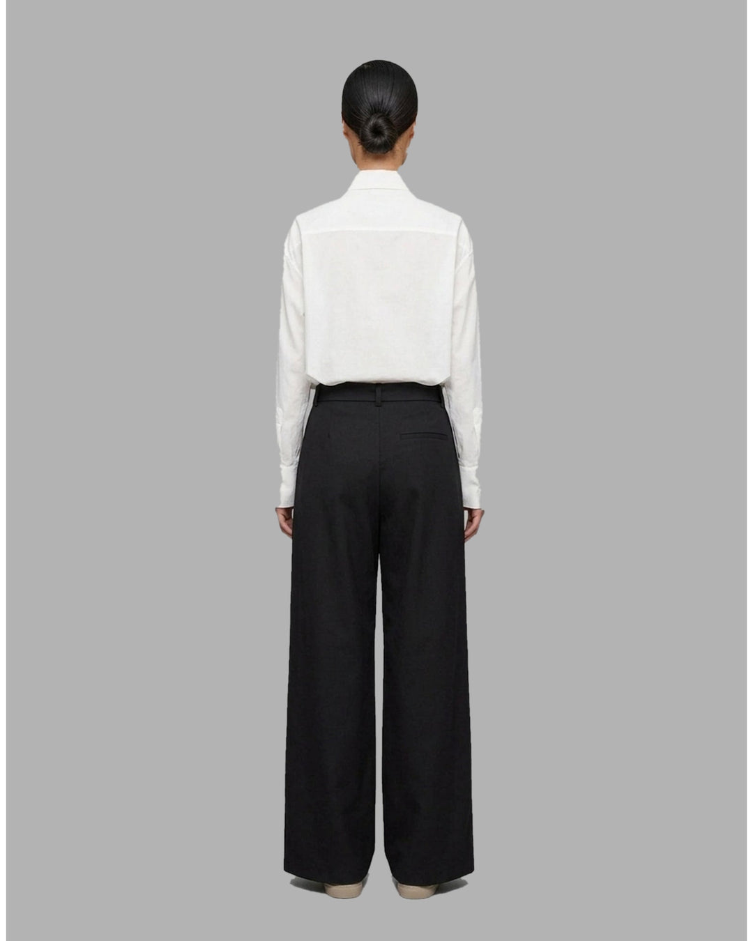 Khaki wide-leg pleated pants with a high-rise waist and self-tie bow belt, shown flat against a white background - back