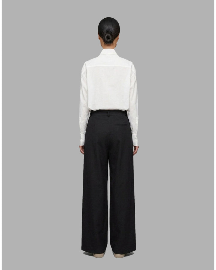 Khaki wide-leg pleated pants with a high-rise waist and self-tie bow belt, shown flat against a white background - back
