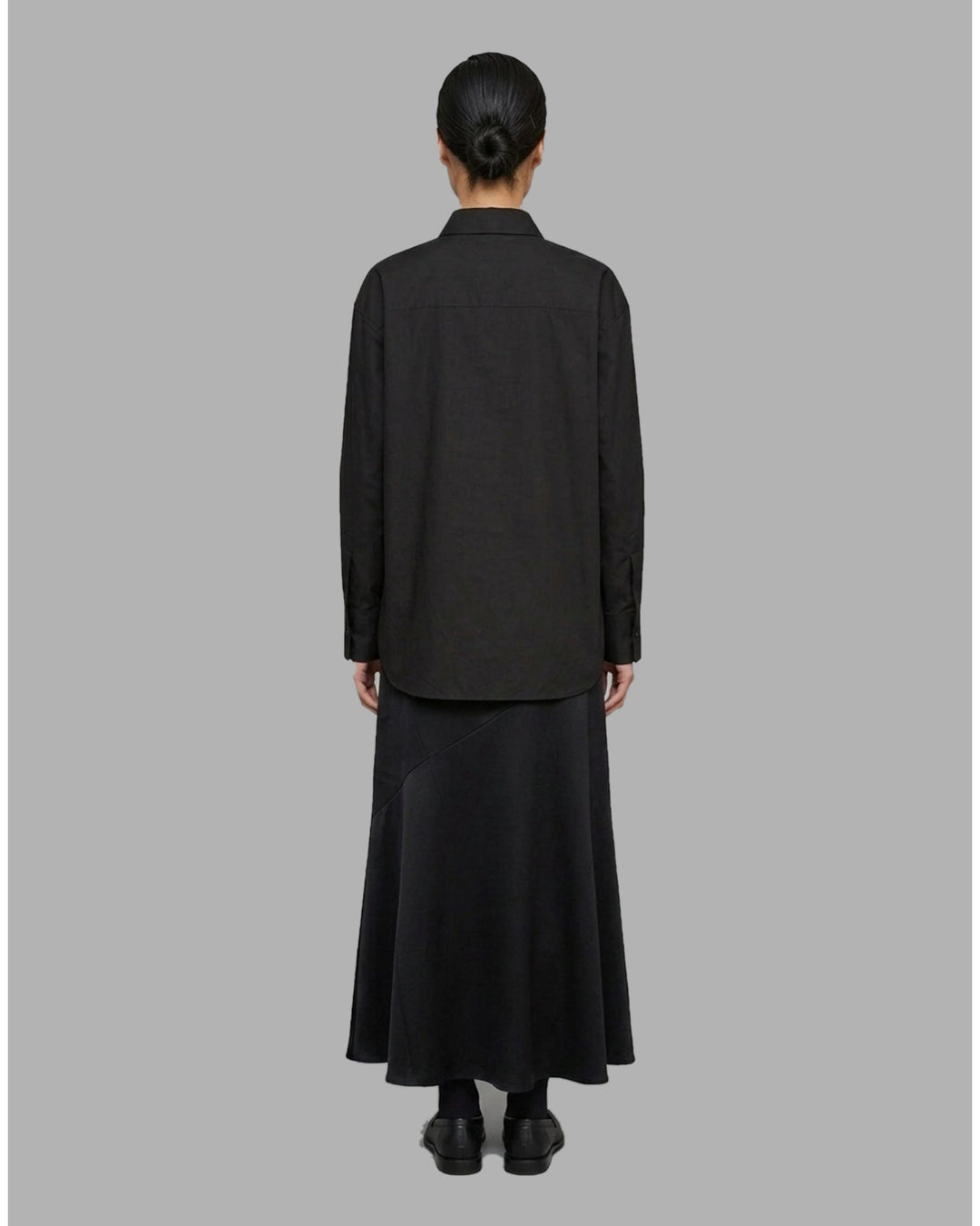 Ivory matte acetate-mix maxi skirt with a diagonal seam and flared hem, shown from the front - back